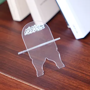Clear acrylic book stand detail view showing intricate Arabic calligraphy and desktop display.