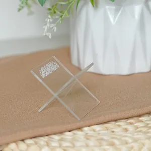 Detailed shot of clear acrylic book stand, decorative desk holder featuring Arabic script text.