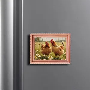 Close-up of a magnetic wooden picture frame with farmhouse chicken and daisy art on a fridge.