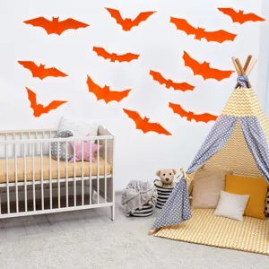 Détail des stickers muraux chauve-souris orange pour la déco de fête d'Halloween.