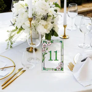 Acrylic table number sign detail view, featuring elegant floral pattern for wedding party decor.