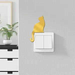 Detailed view of gold mirror acrylic cat switch sticker, modern wall decor accent in home.