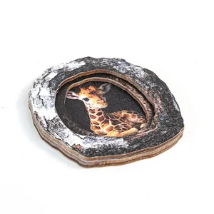 Close-up detail of the wooden tree hollow giraffe decorative fridge magnet piece.