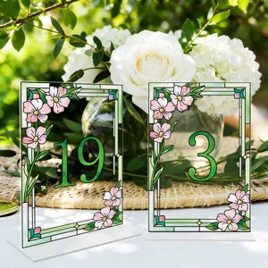 Stained glass acrylic table number sign detail, elegant floral wedding decor piece.