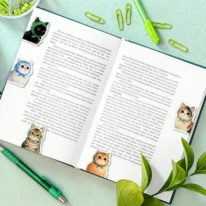 Close-up detail of cute cat magnetic bookmarks attached to an open notebook with stationery.