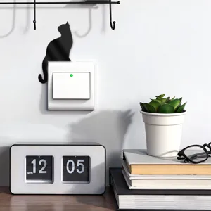 Detailed shot showing the black cat acrylic mirror switch sticker in a home setting.