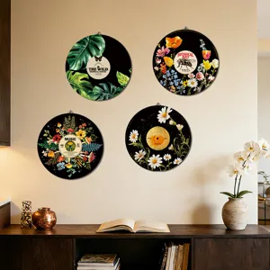 Detail shot of boho wooden wall art featuring botanical vinyl record designs on a living room wall.