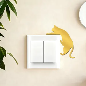 Gold acrylic mirror cat switch sticker, creative wall decor for home interior styling.