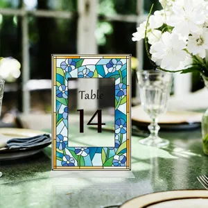 Detailed view of stained glass style blue floral acrylic table number sign for wedding.