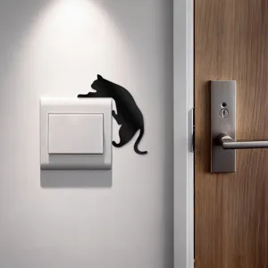 Close-up of a cute black cat wall sticker near the light switch, perfect for home decor.