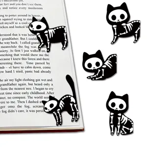 Close up of cute black and white skeleton cat magnetic bookmarks for reading and book lovers.