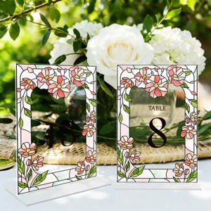 Acrylic table number signs with floral stained glass design for wedding party decor.