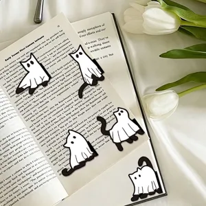 Close-up detail of cute ghost cat magnetic bookmarks placed on an open book with tulips.