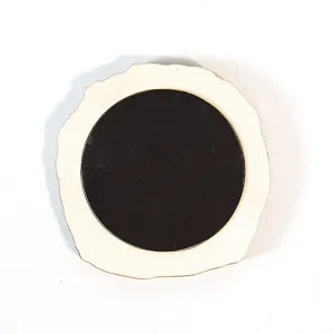 Detailed view of the wooden fridge magnet backside featuring natural wood slice and black magnet.
