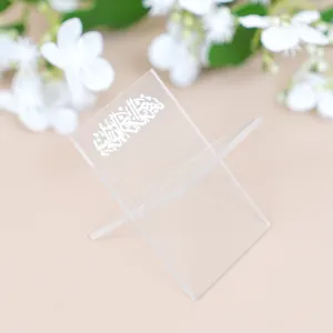 Clear acrylic book stand detail view showing exquisite Arabic calligraphy and elegant transparent design.