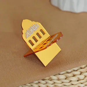 Gold acrylic Islamic book stand detail view, decorative Quran holder with Arabic text.
