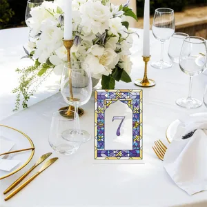 Detail view of acrylic table number sign featuring stained glass style design for weddings.