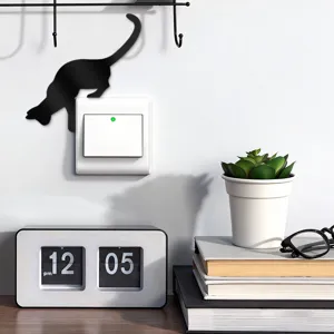 Detailed close-up view of the cute black acrylic cat wall switch sticker in a modern room.