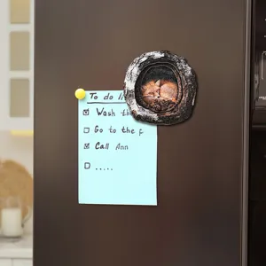 Detailed view of the cute sleeping fox tree hole magnetic sticker decorating a fridge.