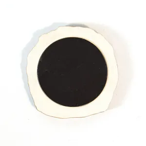 Wooden magnetic decor back detail, natural wood slice with circular black magnet piece.