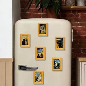 Cute cat art fridge magnets on white vintage refrigerator in kitchen scene decor detail