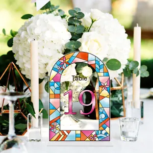 Detailed view of colorful stained glass wedding table number sign 19 decorated on reception table.