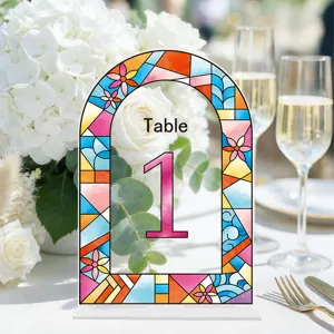 Detailed view of acrylic wedding table number sign with colorful stained glass pattern and stand.