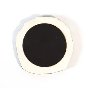 Wooden magnetic sticker detail view, showing the black magnetic back and natural wood shape.