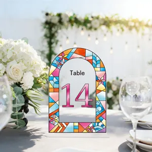 Stained glass style arch table number sign detail, elegant wedding reception tabletop decor.