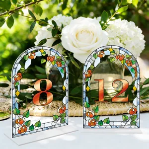 Stained glass style arched acrylic table number card detail for wedding party decoration setup.