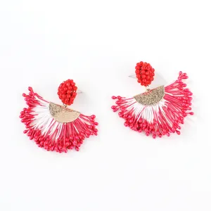 Handmade beaded tassel earrings with red and white fan design and gold accents for women.