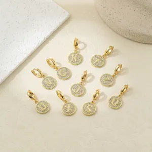 Closeup view of gold letter charms featuring sparkling paved cubic zirconia stones for DIY jewelry.