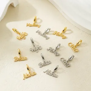 Close-up detail of metal letter word charms, gold and silver DIY jewelry pendants.