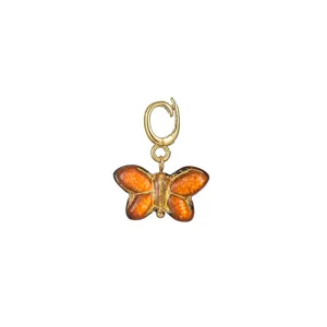 Close-up detail of a gold universal clasp with an amber glass butterfly pendant for DIY jewelry.