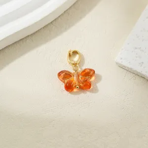Orange glass butterfly charm pendant with gold clasp for DIY jewelry making and crafts.