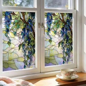 Stained glass window film with blue wisteria floral pattern on white window scene detail.