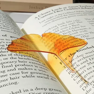 Translucent acrylic leaf bookmark detail shot, yellow gradient ginkgo design for book reading.
