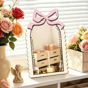 Detailed shot of a decorative wooden mirror with a cute pink bow and inspiring text for bedroom.