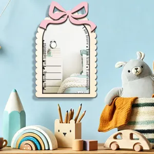 Wooden wall mirror for kids room decor with pink bow and inspirational quotes detail view.