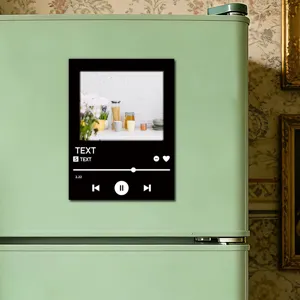 Detail shot of a custom music player acrylic fridge magnet stuck on a green refrigerator.
