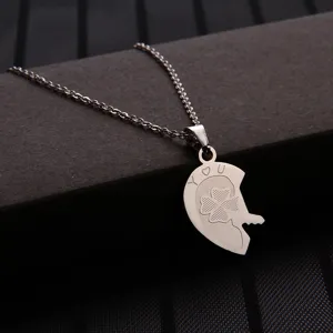 Detailed close-up view of stainless steel heart puzzle key pendant necklace with lucky clover.
