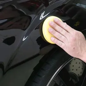Car waxing sponge pad for auto paint care, soft foam polishing applicator tool for cleaning.