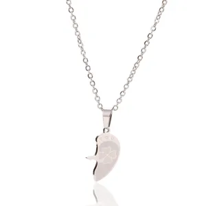 Close-up detail of the stainless steel puzzle heart pendant necklace with clover engraving.