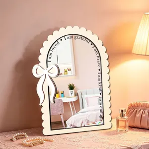 Detailed view of the wooden arched decorative mirror with bow and uplifting text.