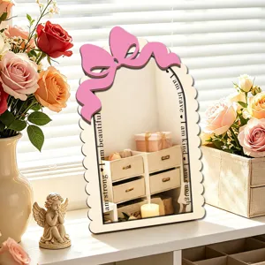 Wooden desktop makeup mirror with pink bow detail and motivational text, tabletop decoration.