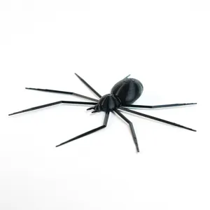 Detailed close-up of a 3D printed black spider holiday decoration, showing intricate layer textures.
