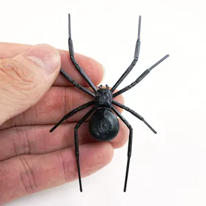 Close-up detail view of a 3D printed black spider fridge magnet showing its unique texture.