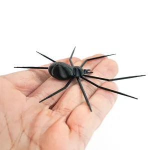 Close-up detail of a 3D printed black spider refrigerator sticker for Halloween decor.
