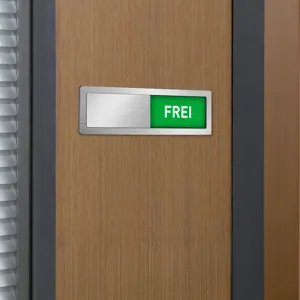 Close-up detail of stainless steel magnetic office sliding door vacant status sign.