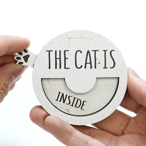 Wooden cat status sign detail view showing sliding mechanism and paw print design.